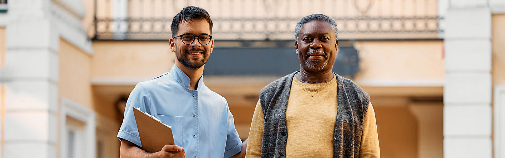 aide and elderly man smiling