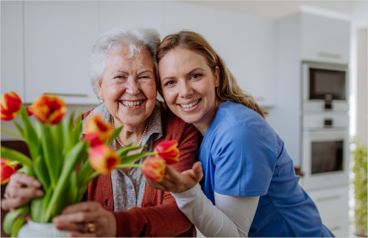 aide and elderly woman smiling