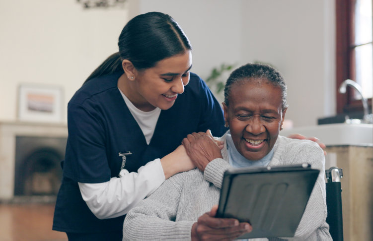 aide and elderly looking at the tablet