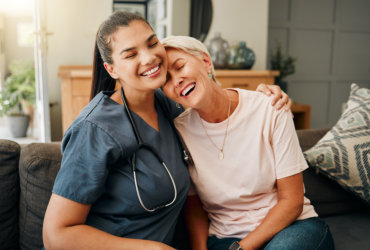 nurse and elderly woman laughing