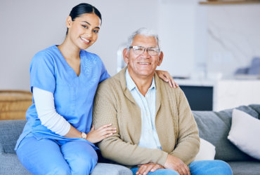 nurse and elderly man smiling