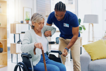 aide assisting an elderly woman