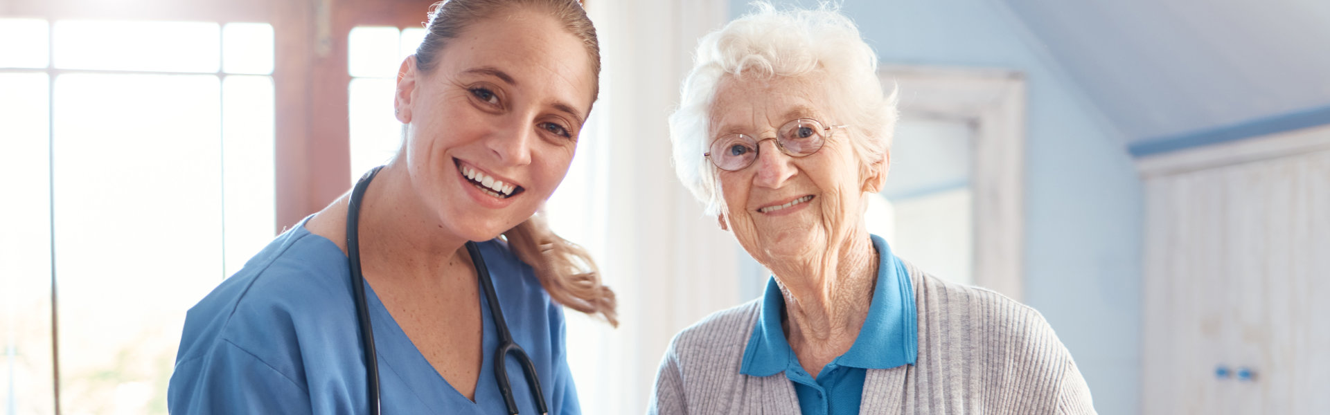 nurse and elderly woman smiling